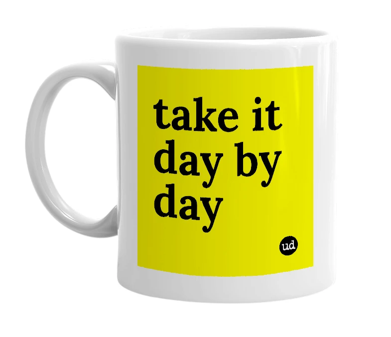 White mug with 'take it day by day' in bold black letters