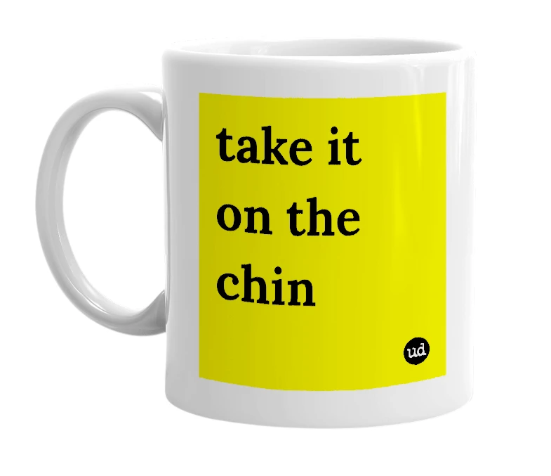 White mug with 'take it on the chin' in bold black letters