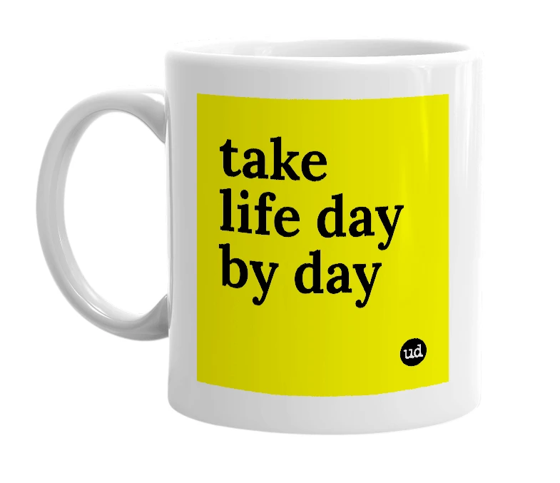 White mug with 'take life day by day' in bold black letters