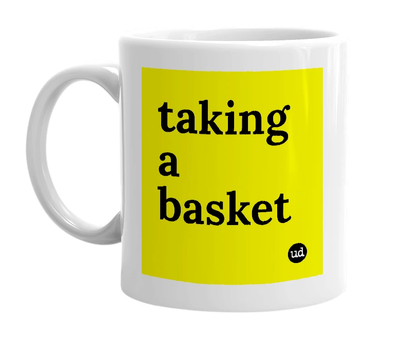 White mug with 'taking a basket' in bold black letters