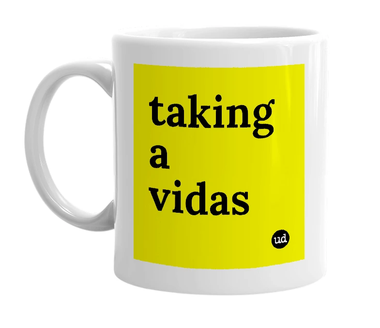 White mug with 'taking a vidas' in bold black letters