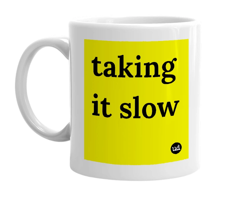 White mug with 'taking it slow' in bold black letters