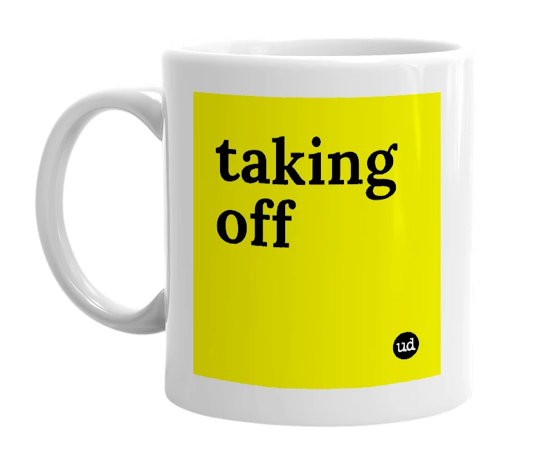 White mug with 'taking off' in bold black letters