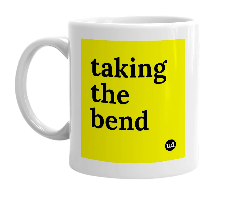 White mug with 'taking the bend' in bold black letters