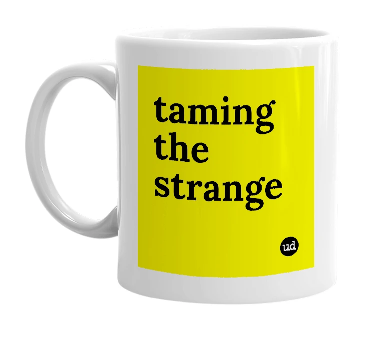 White mug with 'taming the strange' in bold black letters