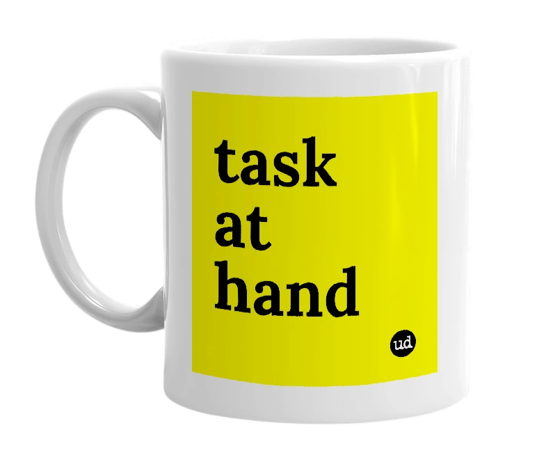 White mug with 'task at hand' in bold black letters