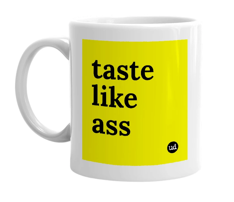 White mug with 'taste like ass' in bold black letters