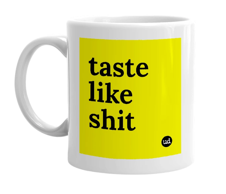 White mug with 'taste like shit' in bold black letters