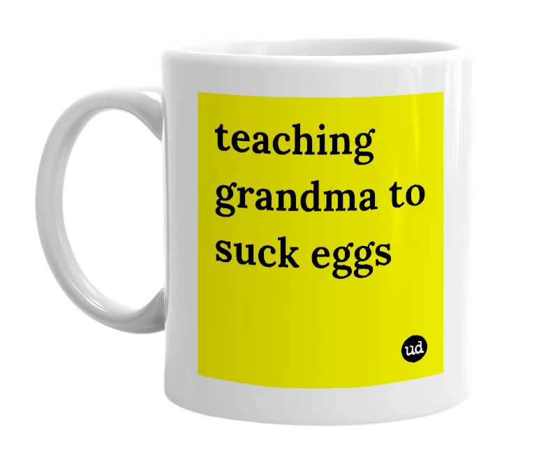 White mug with 'teaching grandma to suck eggs' in bold black letters