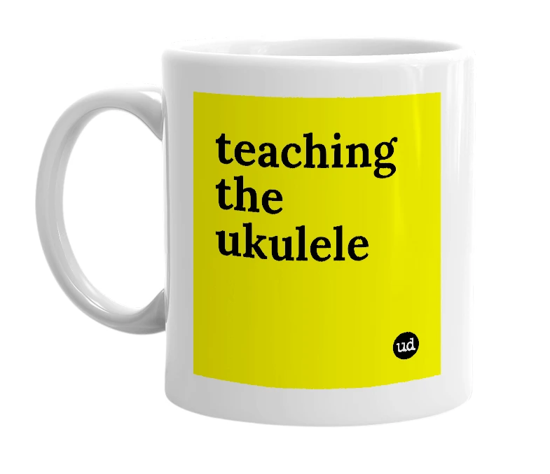 White mug with 'teaching the ukulele' in bold black letters