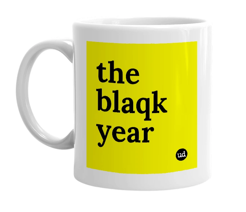 White mug with 'the blaqk year' in bold black letters