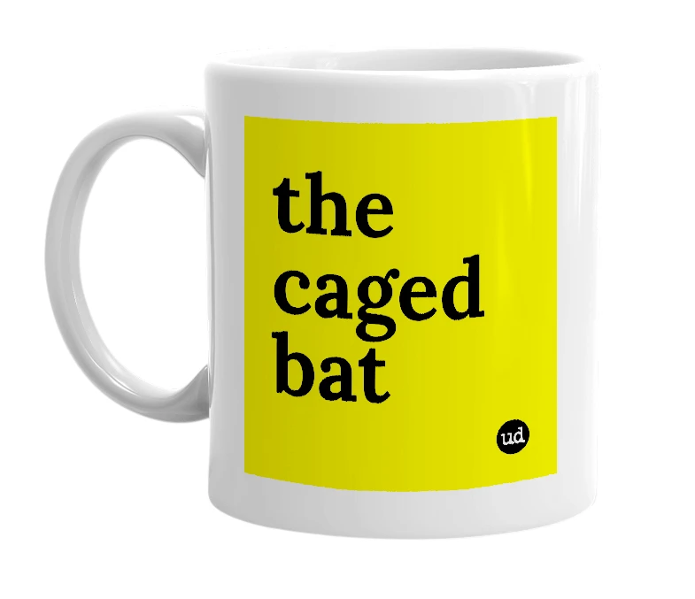 White mug with 'the caged bat' in bold black letters