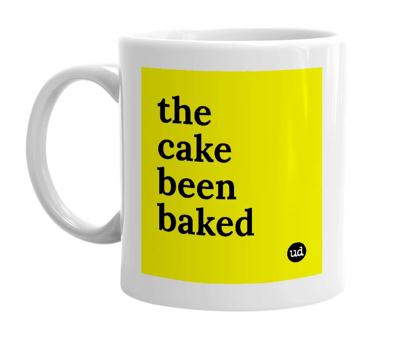 White mug with 'the cake been baked' in bold black letters