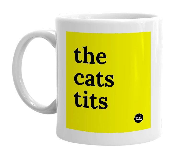 White mug with 'the cats tits' in bold black letters