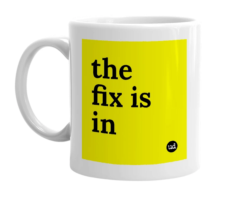 White mug with 'the fix is in' in bold black letters