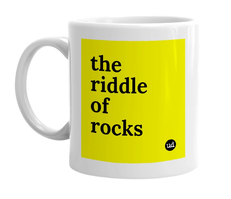 White mug with 'the riddle of rocks' in bold black letters