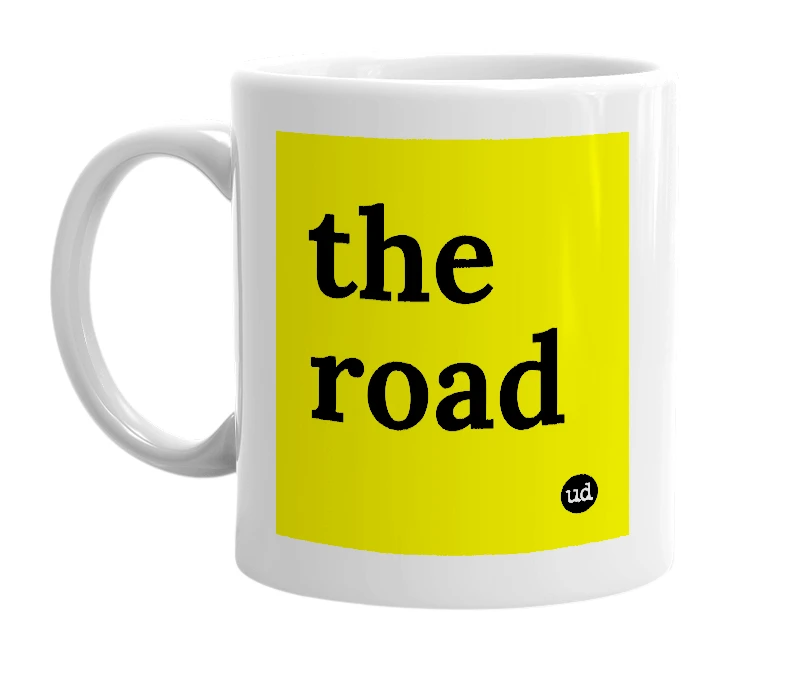 White mug with 'the road' in bold black letters