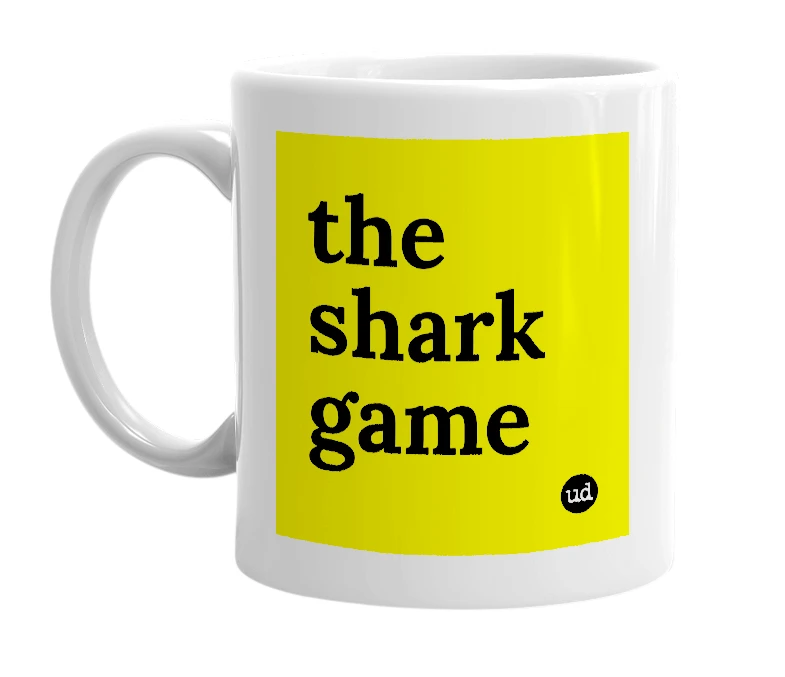White mug with 'the shark game' in bold black letters