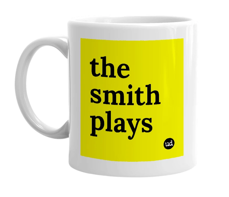 White mug with 'the smith plays' in bold black letters