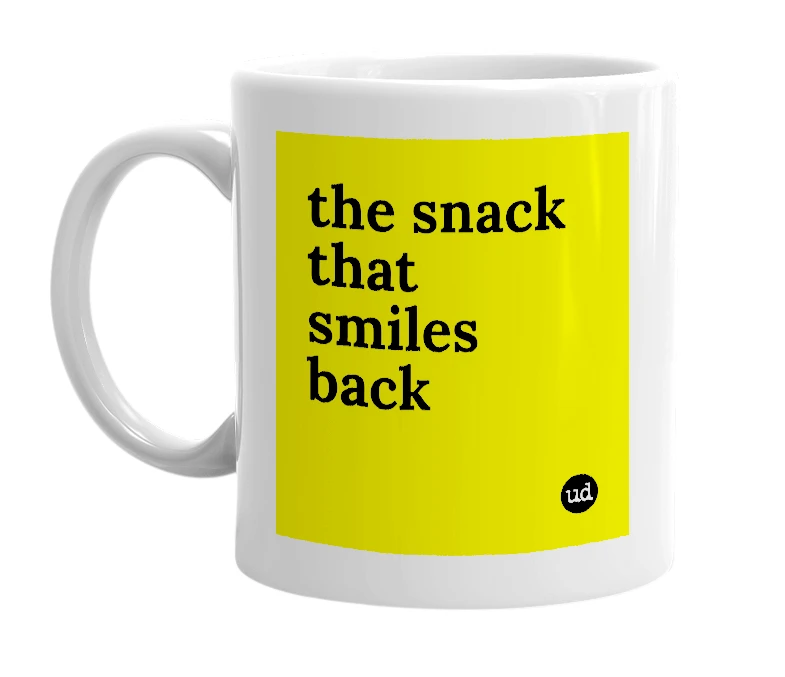 White mug with 'the snack that smiles back' in bold black letters