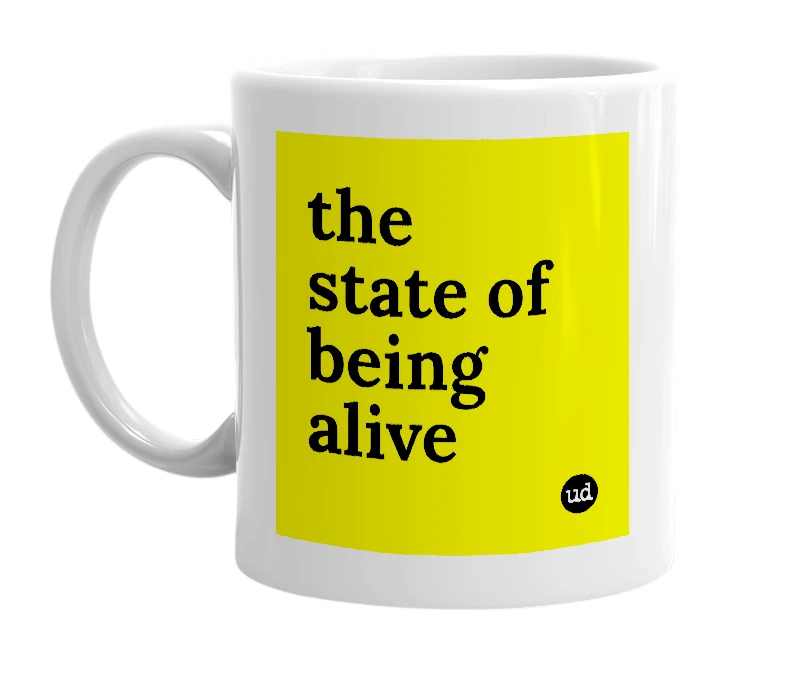 White mug with 'the state of being alive' in bold black letters