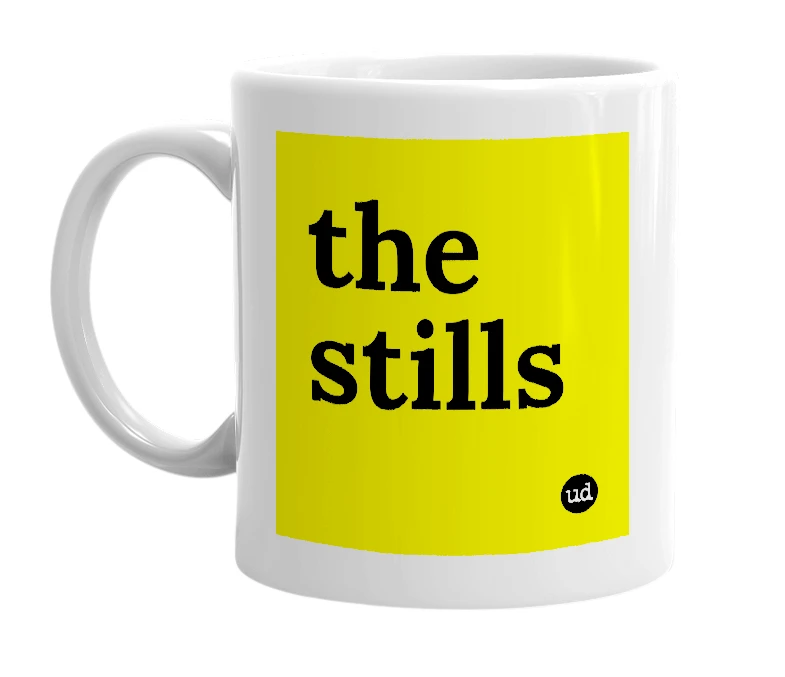 White mug with 'the stills' in bold black letters