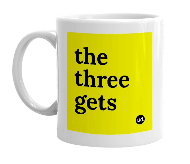 White mug with 'the three gets' in bold black letters