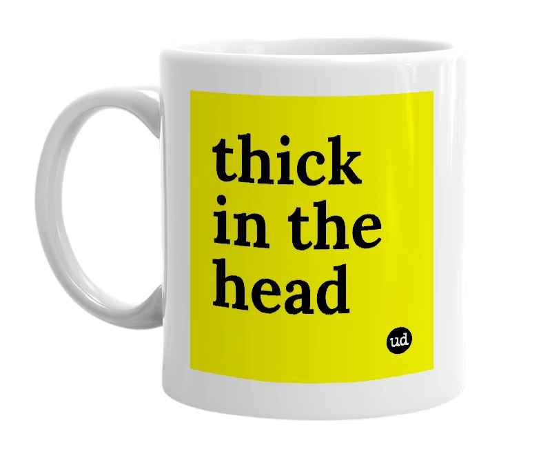 White mug with 'thick in the head' in bold black letters