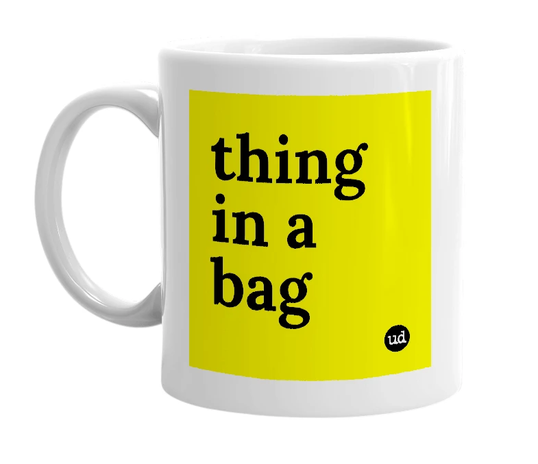 White mug with 'thing in a bag' in bold black letters