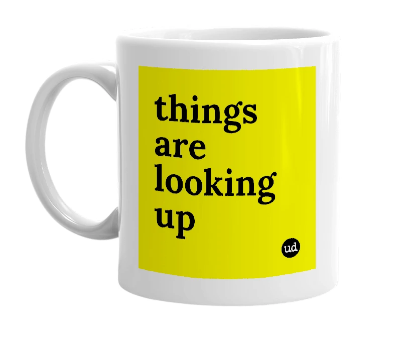 White mug with 'things are looking up' in bold black letters