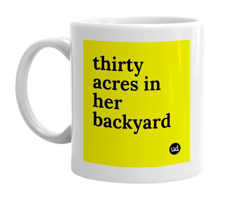 White mug with 'thirty acres in her backyard' in bold black letters