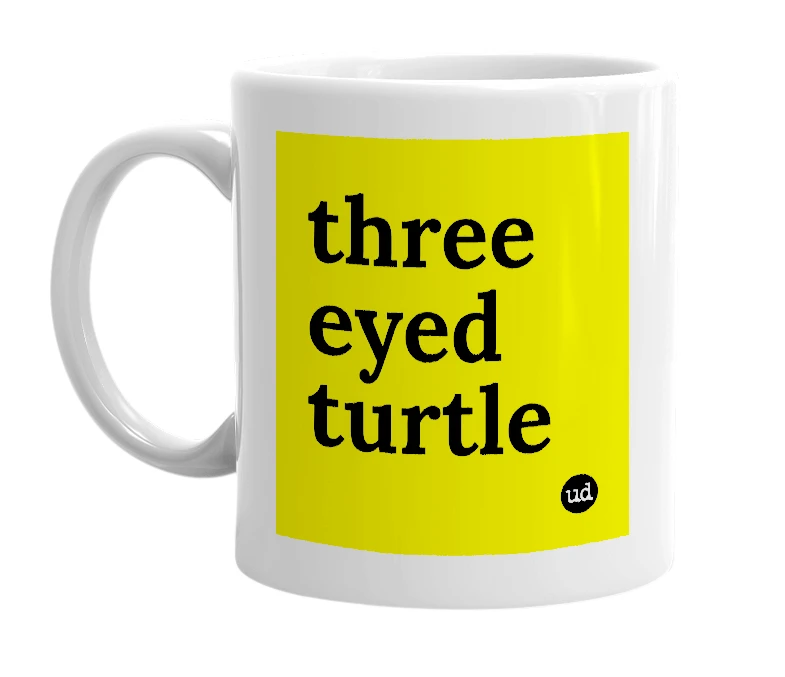 White mug with 'three eyed turtle' in bold black letters