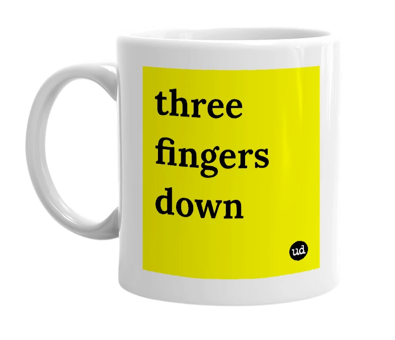 White mug with 'three fingers down' in bold black letters