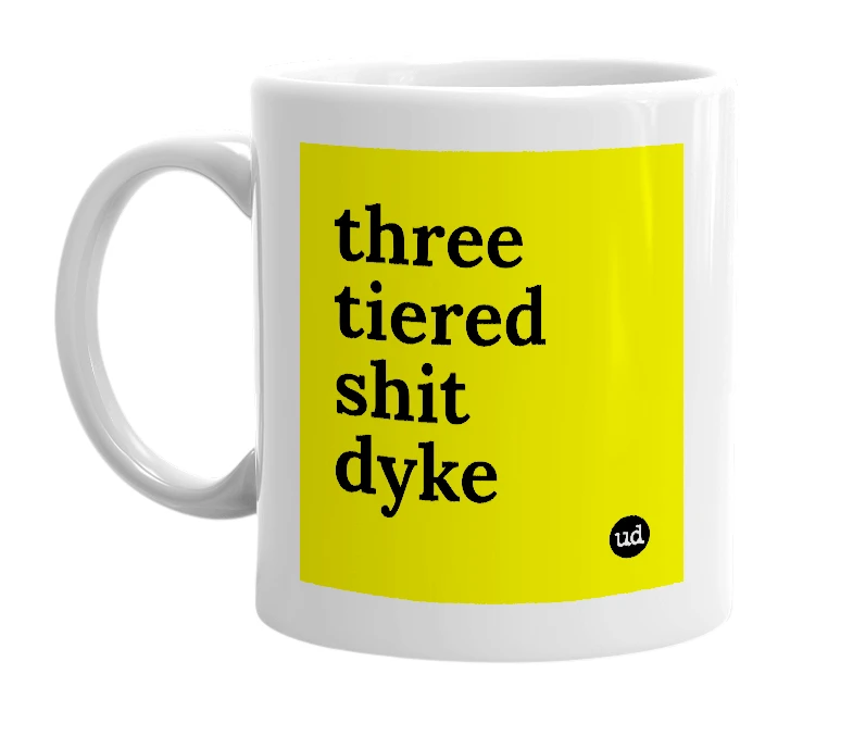 White mug with 'three tiered shit dyke' in bold black letters