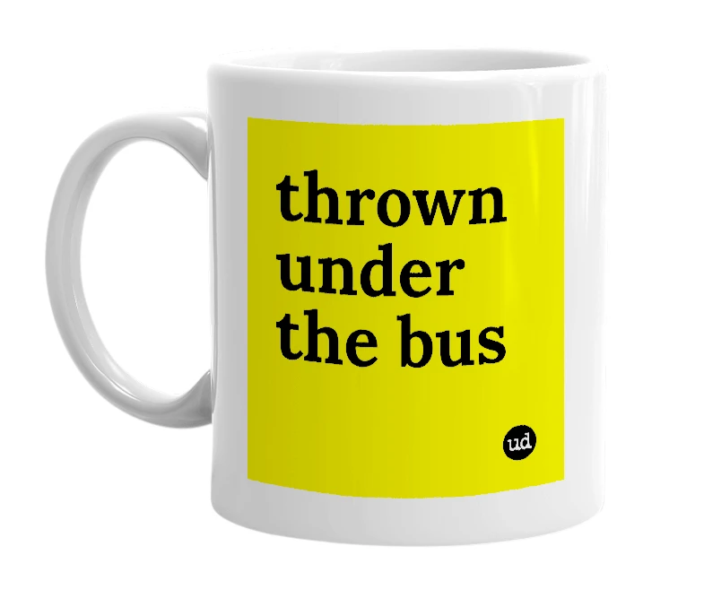 White mug with 'thrown under the bus' in bold black letters