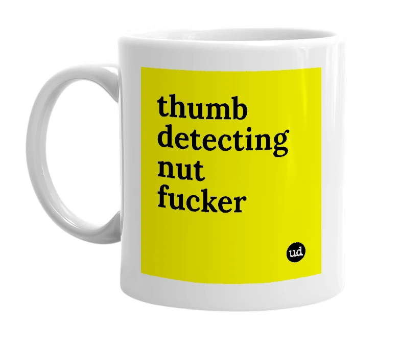 White mug with 'thumb detecting nut fucker' in bold black letters