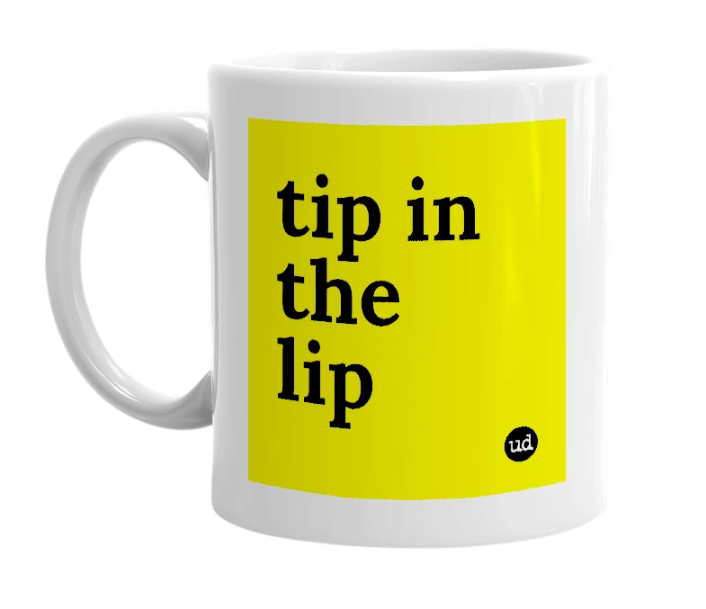 White mug with 'tip in the lip' in bold black letters