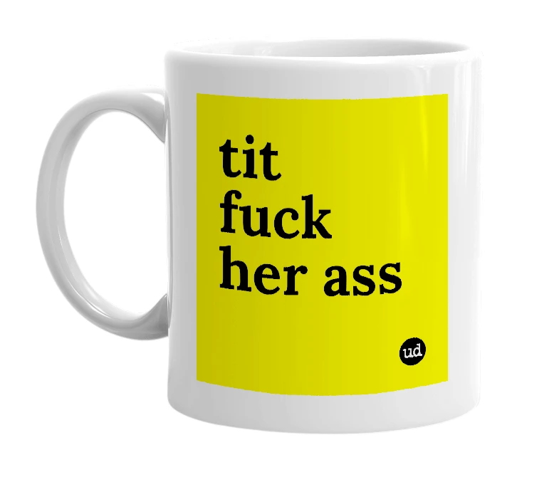 White mug with 'tit fuck her ass' in bold black letters