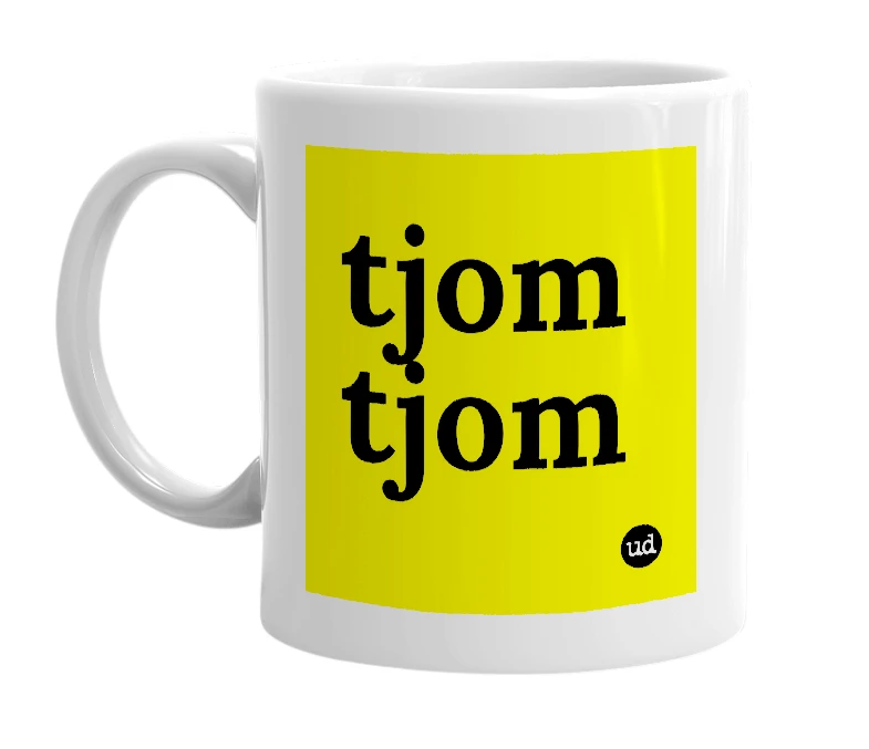 White mug with 'tjom tjom' in bold black letters