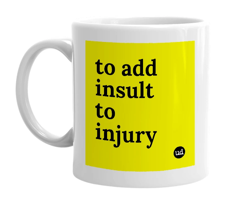 White mug with 'to add insult to injury' in bold black letters