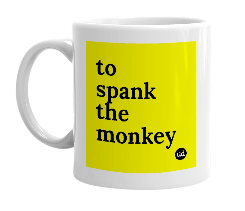 White mug with 'to spank the monkey' in bold black letters