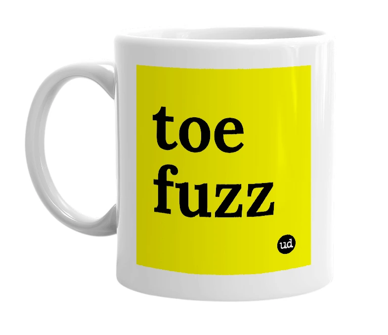 White mug with 'toe fuzz' in bold black letters