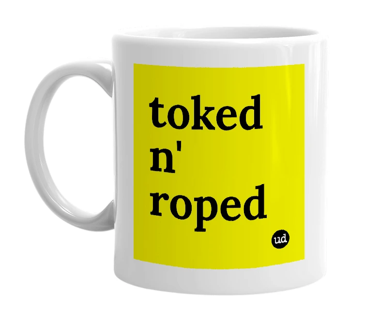 White mug with 'toked n' roped' in bold black letters