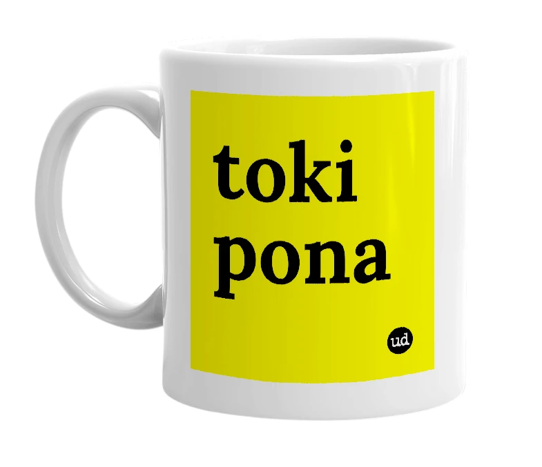 White mug with 'toki pona' in bold black letters