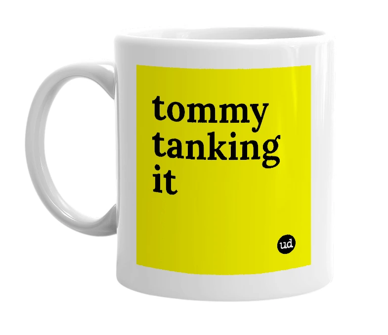 White mug with 'tommy tanking it' in bold black letters