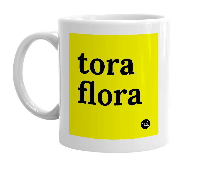 White mug with 'tora flora' in bold black letters