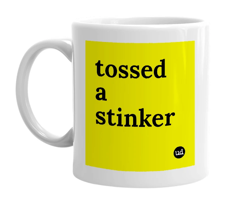 White mug with 'tossed a stinker' in bold black letters