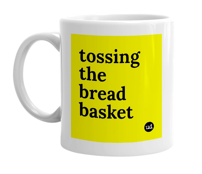 White mug with 'tossing the bread basket' in bold black letters