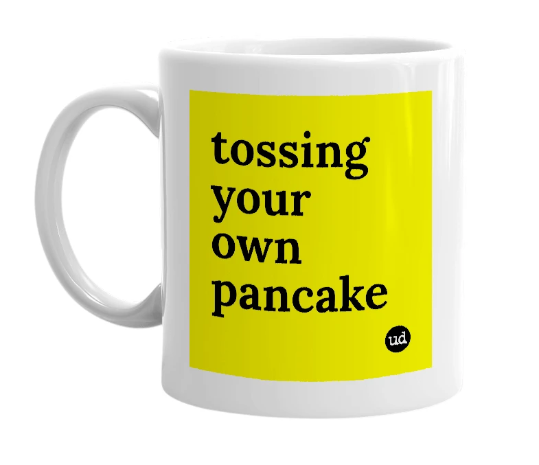 White mug with 'tossing your own pancake' in bold black letters
