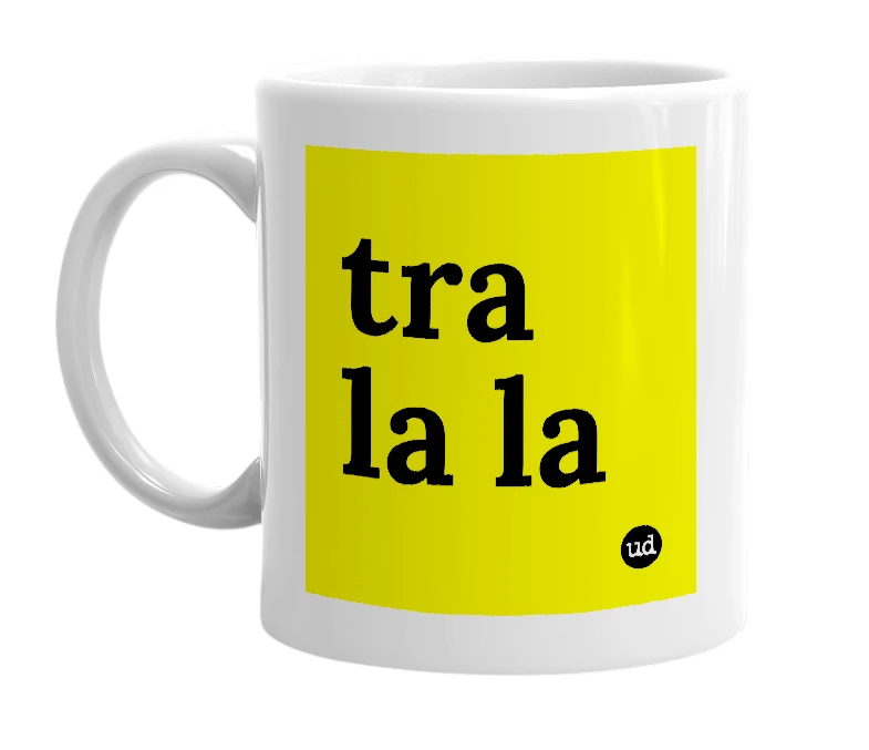 White mug with 'tra la la' in bold black letters